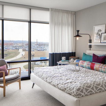 Light filled bedrooms with floor-to-ceiling glass windows offering gorgeous waterfront views.