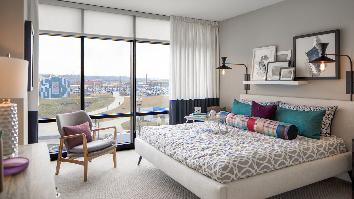 Light filled bedrooms with floor-to-ceiling glass windows offering gorgeous waterfront views 