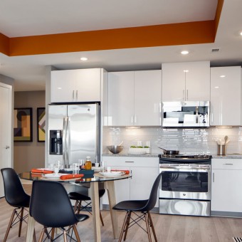 Stunning kitchens with designer white cabinetry with pantries and under-counter lighting.
